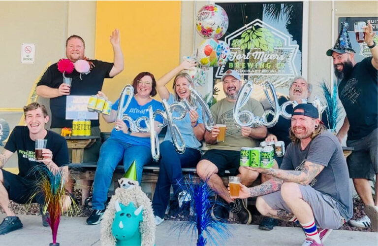 A group of people posing for a photo with balloons.