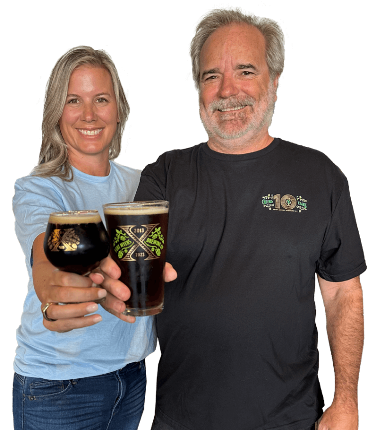 Rob and Jen Whyte holding a glass of beer.